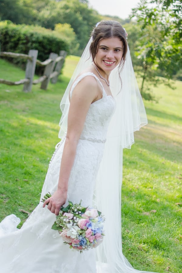 Bride holding bouquet at Caterham Wedding