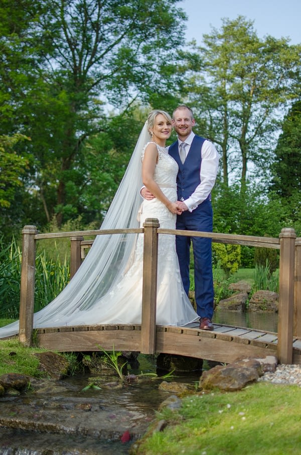 Bride and groom on Coltsford Mill bridge