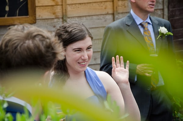 Wedding guest waving at Coltsford Mill